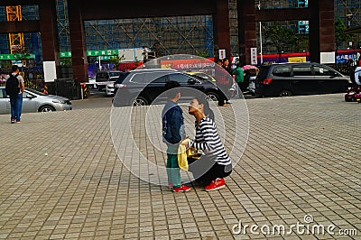 Shenzhen, China: Young mothers or grandmothers play outdoors with their children Editorial Stock Photo