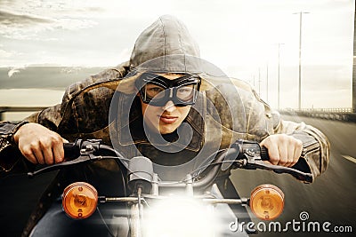 Young motorcyclist driving on a road Stock Photo