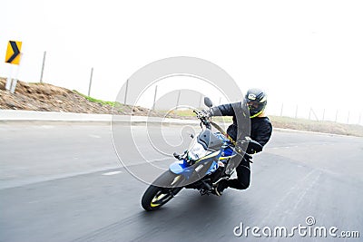 Young motorcyclist on a Susuki bike driving on a road Editorial Stock Photo