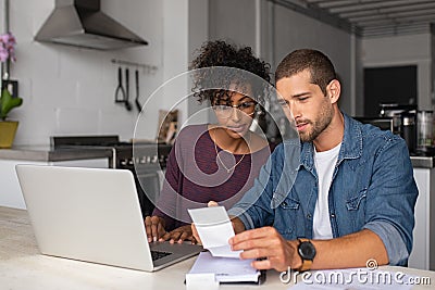 Young multiethnic couple examining home finance Stock Photo