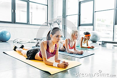 young multiethnic female athletes doing exercise on fitness mats Stock Photo