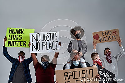 Young multiracial protestors and kid holding anti racist posters Editorial Stock Photo