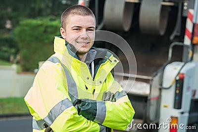 Young municipal garbage collector near garbage truck Stock Photo