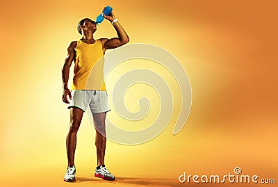 Young muscular build man drinking water of bottle Stock Photo