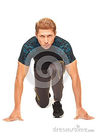 Young muscular handsome sportsman preparing to start running Stock Photo