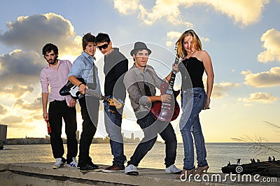 Young musical band posing with instruments Stock Photo