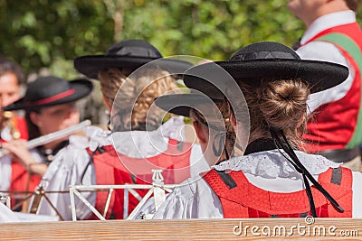 Young musician girl in typical costume during an autumn local celebration in Val di Funes South Tyrol Editorial Stock Photo