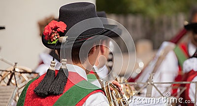 Young musician in typical costume during an autumn local celebration in Val di Funes ( South Tyrol ) Editorial Stock Photo