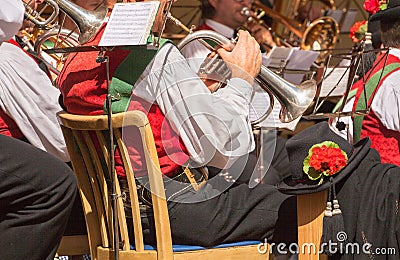 Young musician in typical costume during an autumn local celebration in Val di Funes ( South Tyrol ) Editorial Stock Photo