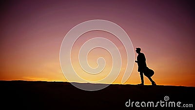 Handsome male Arab playing guitar standing in middle of bottomle Stock Photo