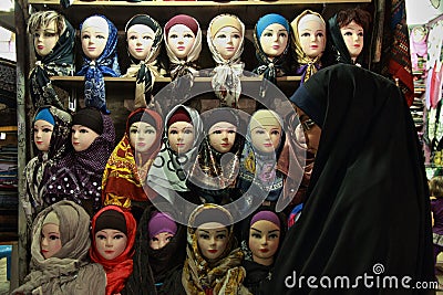 Young Muslim woman in front of the bazaar scarves stand Editorial Stock Photo