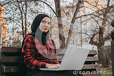 Young muslim woman typing on laptop Stock Photo