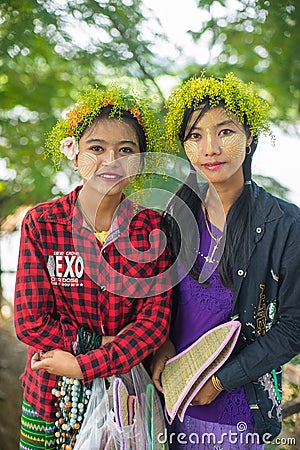 Young Myanmar girls with thanaka on her face is happiness Editorial Stock Photo