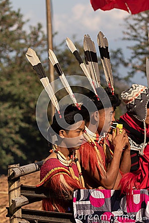 Young Naga boy siting wearing colorful attire and head gears Editorial Stock Photo