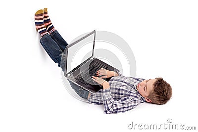 Young nerd boy lying on floor using a laptop with empty white sc Stock Photo