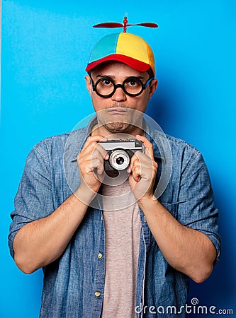 Young nerd man with noob hat holding camera Stock Photo