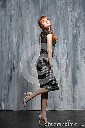 Young nice redhead lady posing in studio Stock Photo