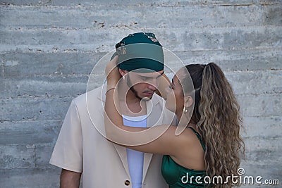 Young, non-conformist Latino and Hispanic boy and girl couple looking at each other while she ties his headscarf. Concept love, Stock Photo