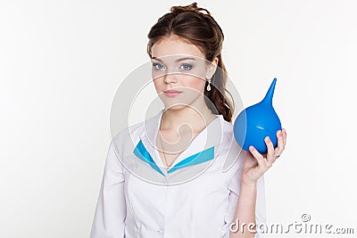 Young nurse with blue enema in hands Stock Photo