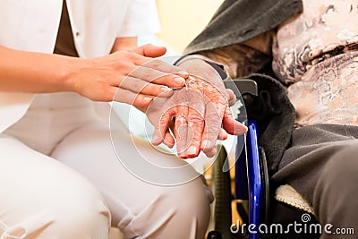 Young nurse and female senior in nursing home Stock Photo