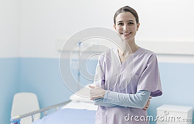 Young nurse posing next to a hospital bed Stock Photo