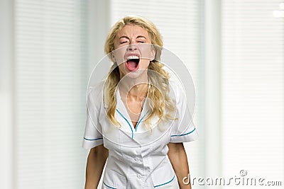 Young nurse screaming in despair. Stock Photo