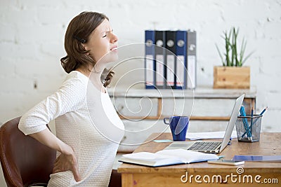 Young office woman feeling backache Stock Photo