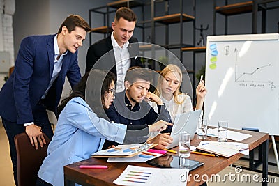 Young office workers using laptop at workplace Stock Photo