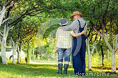 Young and older together in orchard Stock Photo