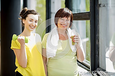 Young and older woman exercising indoors Stock Photo