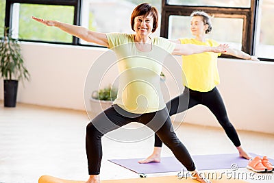 Young and older women doing yoga Stock Photo