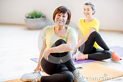 Young and older women doing yoga Stock Photo