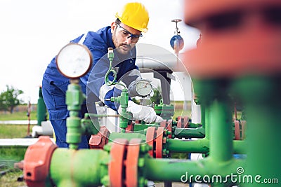 Operator recording operation of oil and gas process at oil and rig plant Stock Photo