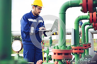 Operator recording operation of oil and gas process at oil and rig plant Stock Photo