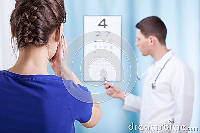 Young ophthalmologist performs eye examination Stock Photo