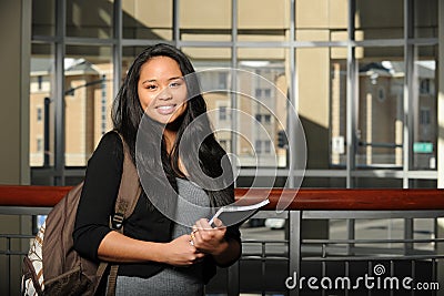 Young Oriental Woman Student holding a copybook Stock Photo