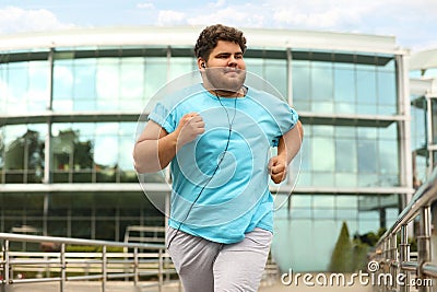 Young overweight man running. Fitness lifestyle Stock Photo