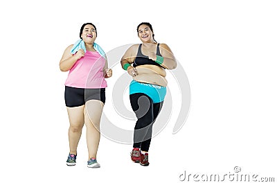 Young overweight women jogging together in studio Stock Photo