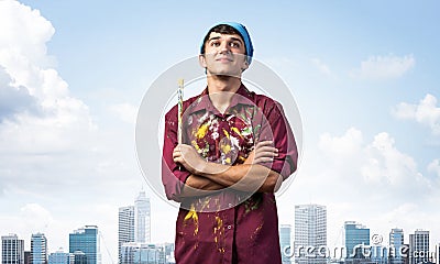 Young painter artist standing with folded arms Stock Photo