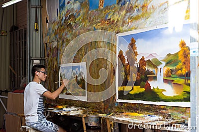 Young painter painting picture Editorial Stock Photo