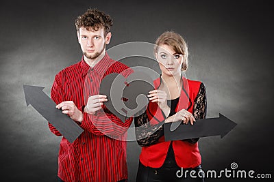 Young pair showing heartbreak symbols. Stock Photo