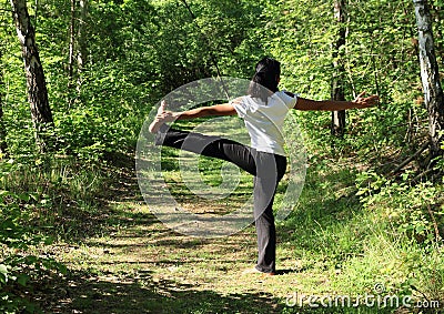 Girl exercising yoga - Parivrtta Hasta Padangusthasana Stock Photo