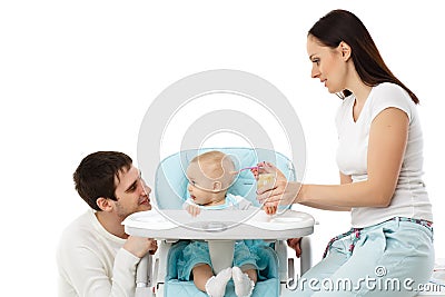 Young parents feed baby. Stock Photo