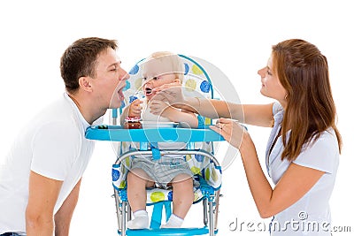 Young parents feed baby. Stock Photo