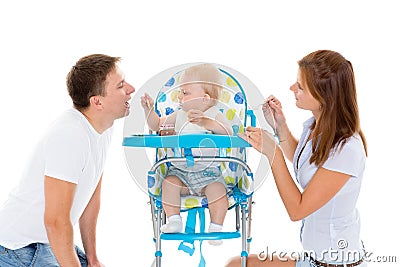 Young parents feed baby. Stock Photo