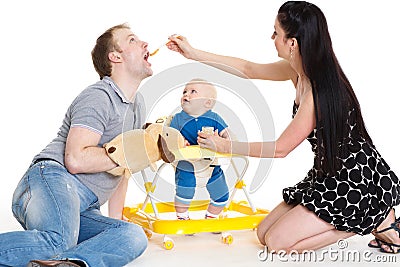 Young parents feed baby. Stock Photo