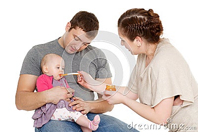 Young parents feed baby. Stock Photo