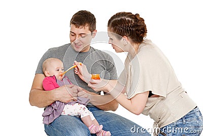 Young parents feed baby. Stock Photo