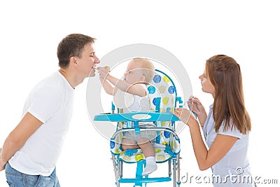 Young parents feed baby. Stock Photo