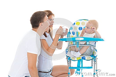 Young parents feed baby. Stock Photo